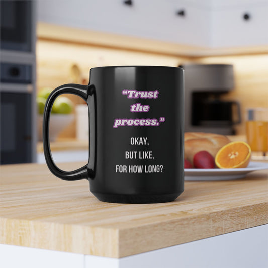 Black mug with humorous text on a kitchen counter