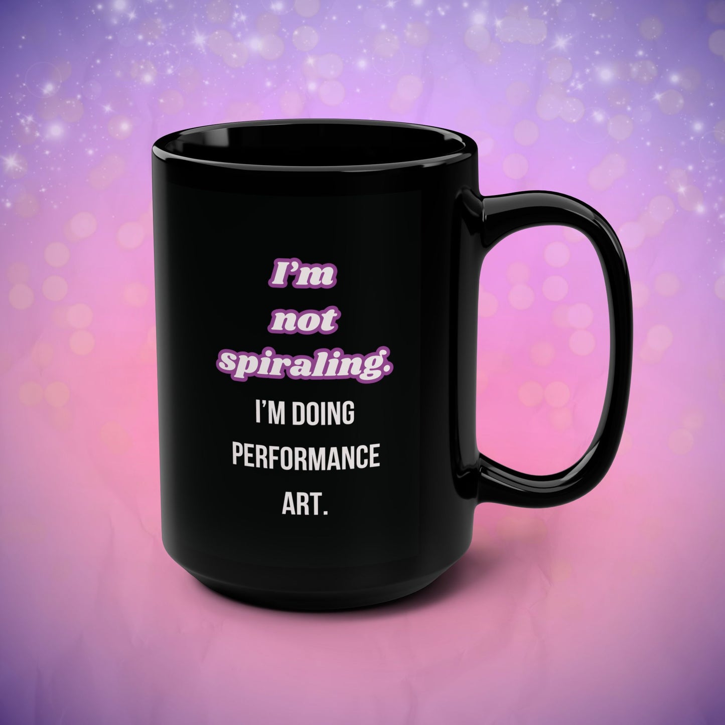 Black mug with text on a purple and pink gradient background