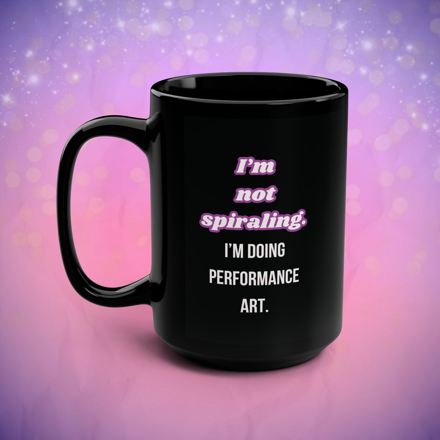 Black mug with text on a purple and pink gradient background