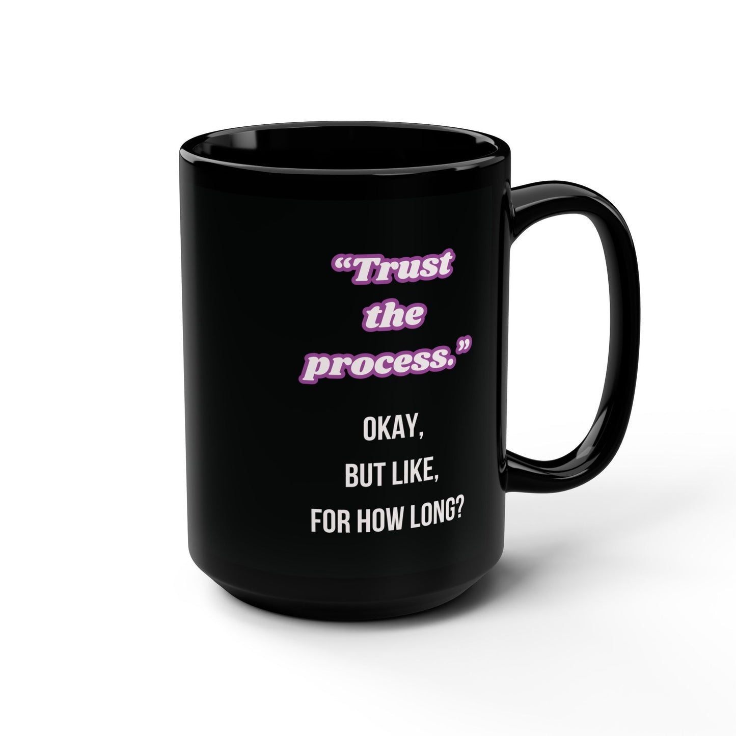 Black mug with humorous text design on a white background