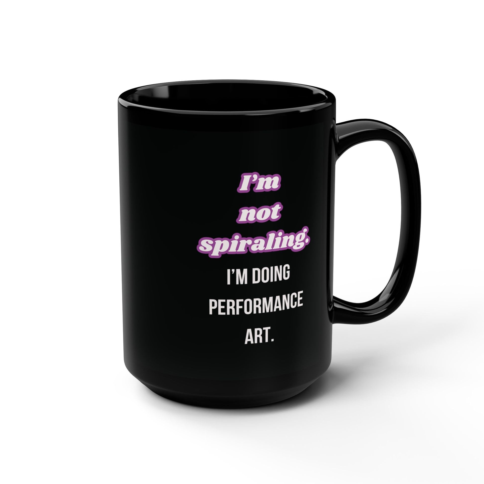 Black mug with pink and white text on a white background