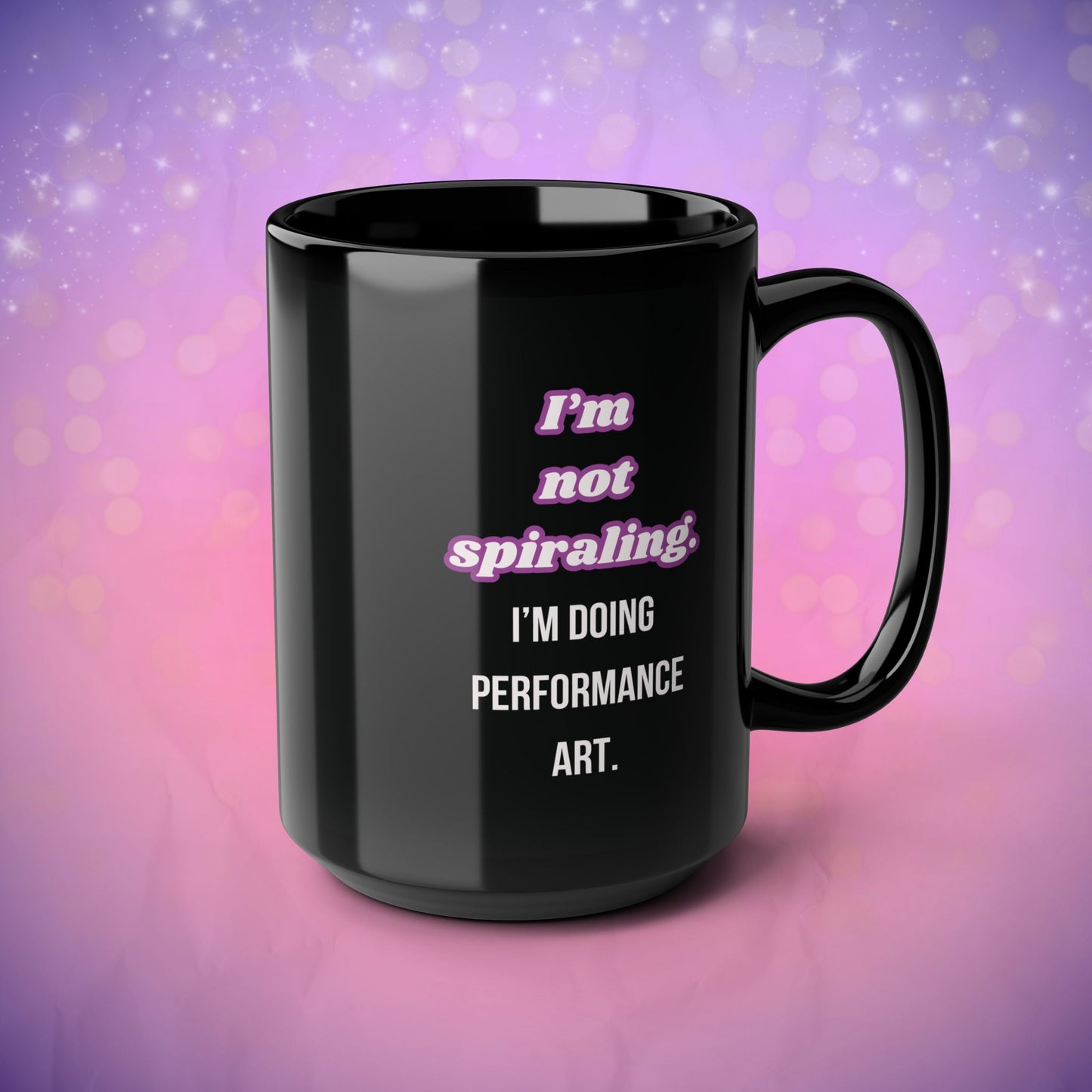 Black mug with humorous text design on a gradient purple and pink background