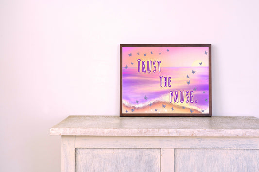 Framed beach-themed printable art with text “Trust the Pause.” over a violet-orange ocean sunset with scattered butterflies; calming inspirational wall art download by Imagination Creations.