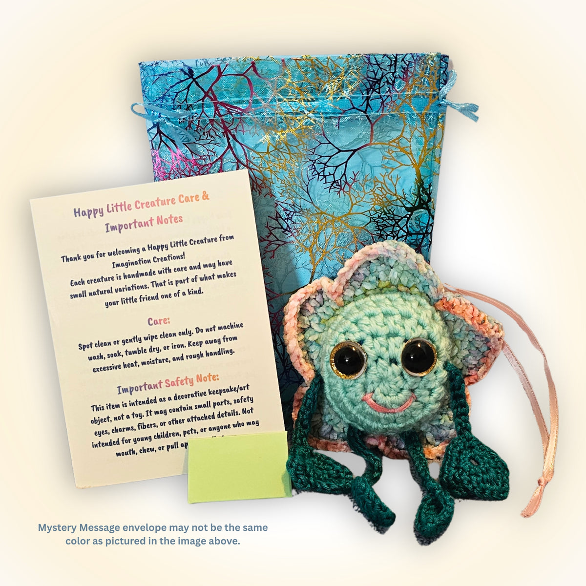 Floyd Flower Boy displayed with decorative packaging, Happy Little Creature care information, and the tiny envelope for his Mystery Message.