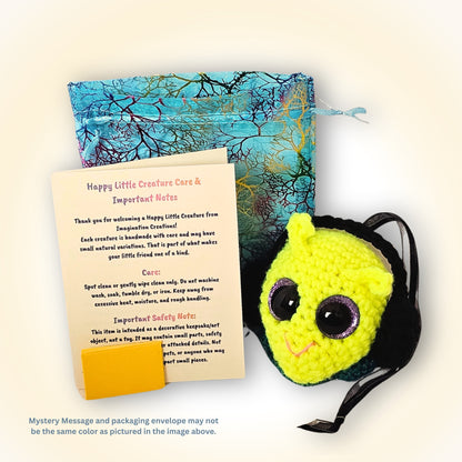 Groovy Gus displayed beside decorative packaging and Happy Little Creature care and safety information.