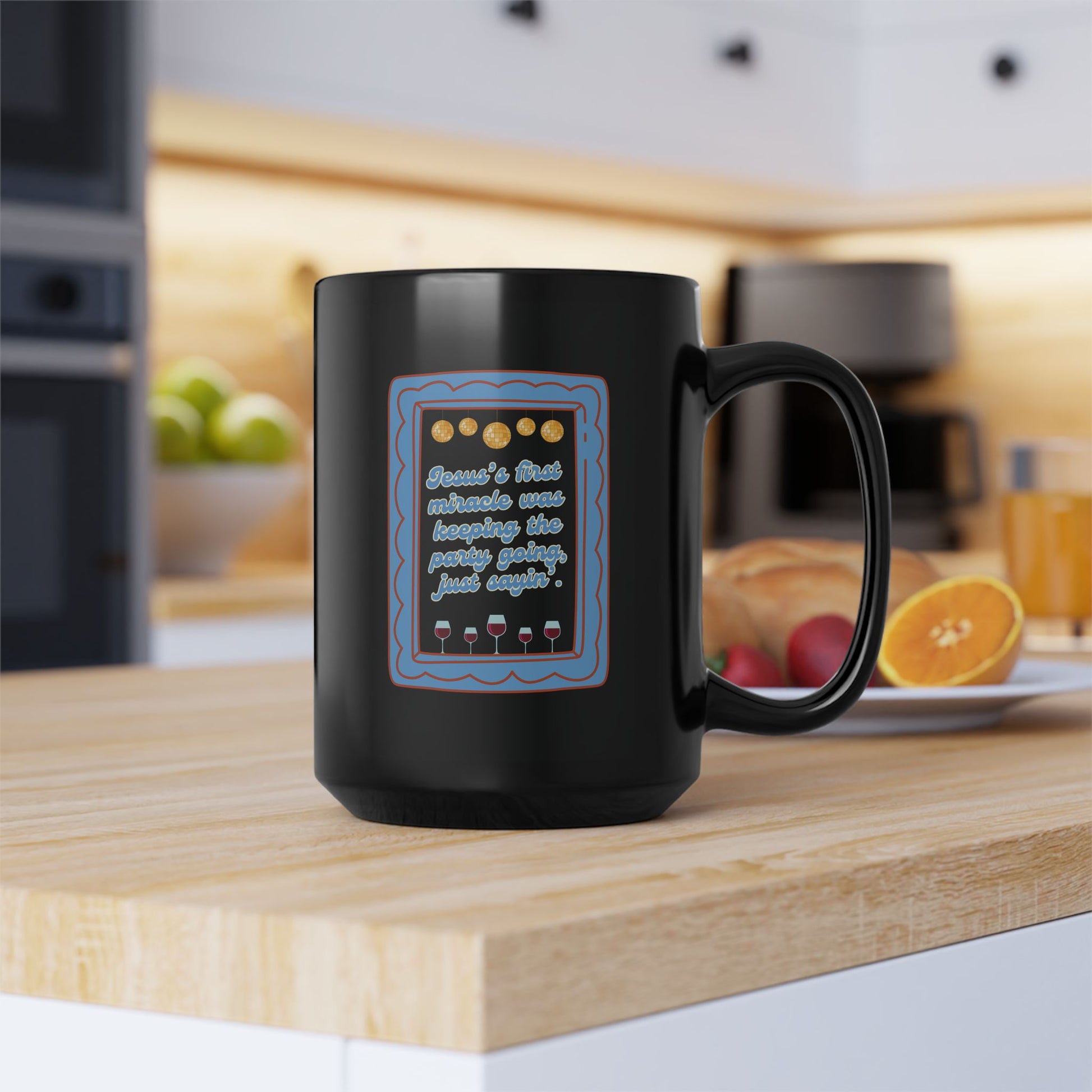 Black mug with a graphic design on a kitchen counter