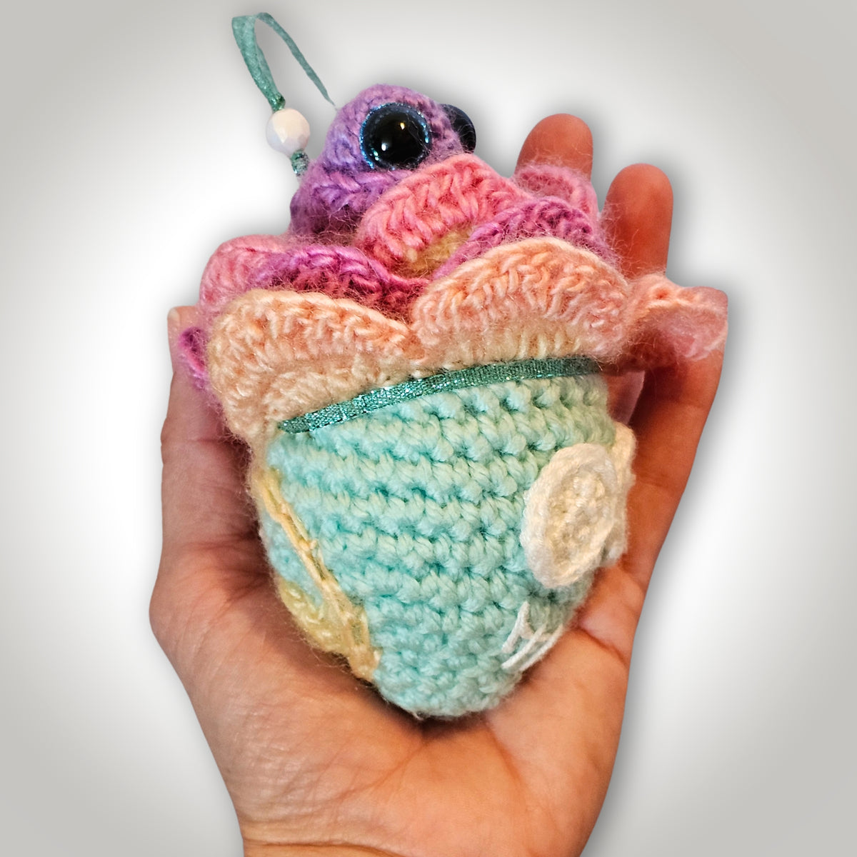 Handheld side view of Paisley Peacebones showing the layered flower petals, and the dimensional shape of the handmade spooky keepsake.
