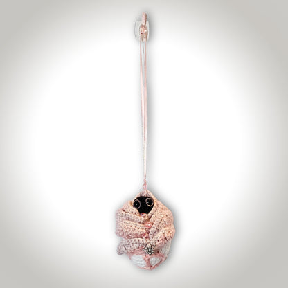 Full hanging back view of Skelly Rose showing the layered flower construction, hidden black sprite, decorative beads, spider detail, and pink ribbon.
