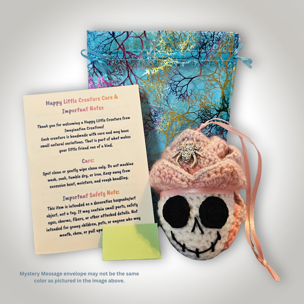 Skelly Rose displayed beside decorative packaging and Happy Little Creature care and safety information.