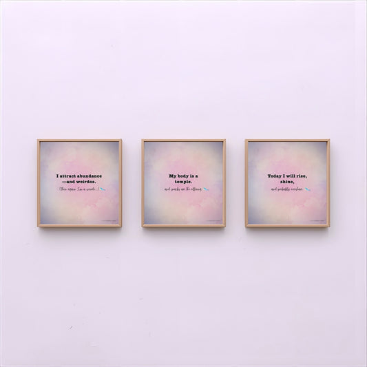 Three framed prints with motivational quotes on a light purple wall.