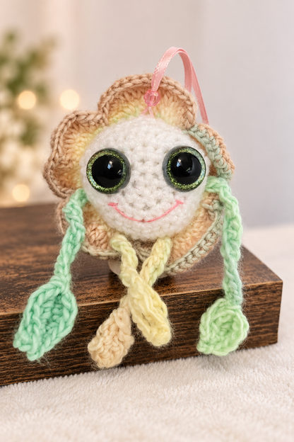 Mellow Marigold sitting on a wooden display stand showing his soft golden petals and leafy green arms.