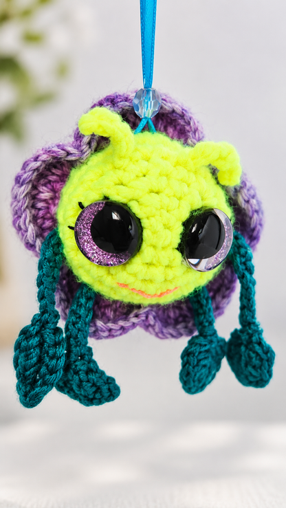 Front view of Pitalian the alien showing neon yellow face, dark green limbs, and purple petals.