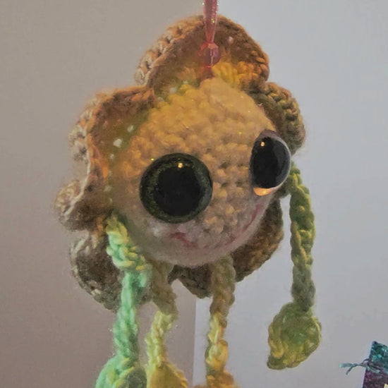 Mellow Marigold Crochet Happy Little Creature turning while hanging to see the view from all angles