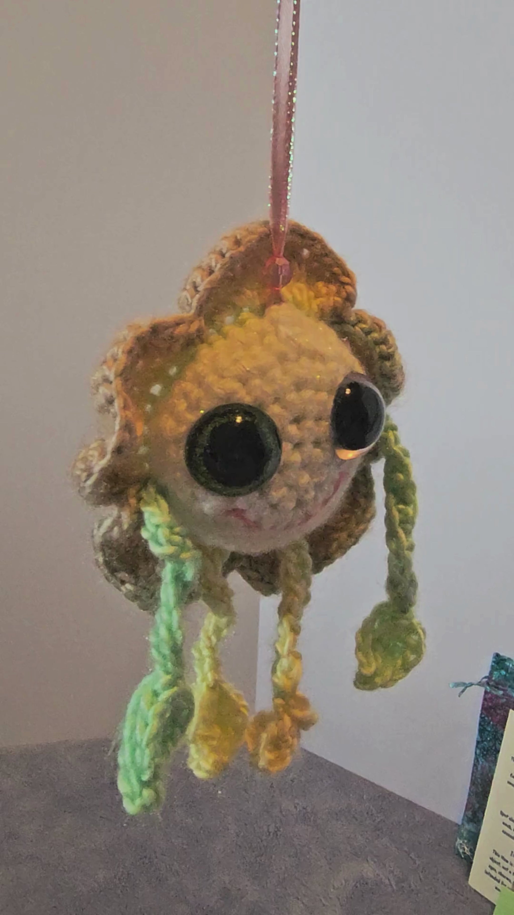 Mellow Marigold Crochet Happy Little Creature turning while hanging to see the view from all angles